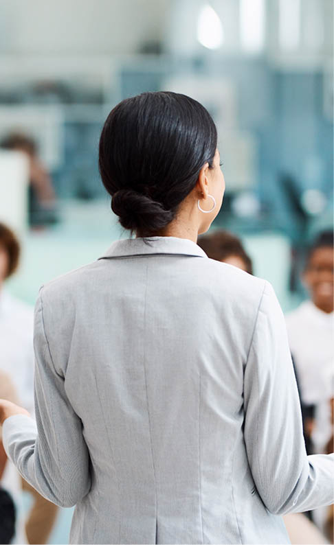 Rearview shot of an unrecognizable businesswoman giving a presentation in the office boardroom